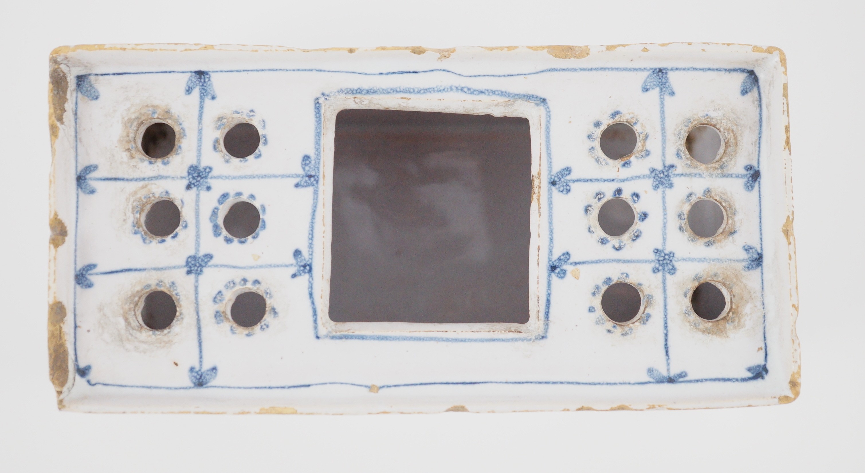 An English delftware flower brick, mid 18th century, 14.5cm wide, chips and crack